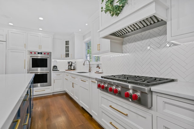 25 Conrad Rd, New Canaan, CT 06840 - kitchen with stainless steel appliances, a sink, light countertops, custom range hood, and decorative backsplash