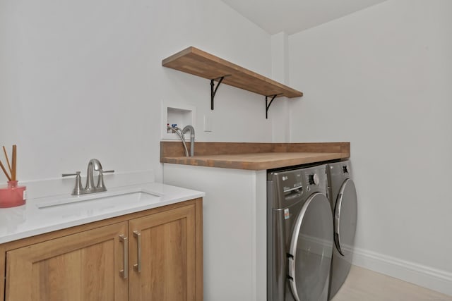 25 Conrad Rd, New Canaan, CT 06840 - laundry area featuring washer and clothes dryer, baseboards, cabinet space, and bar with sink