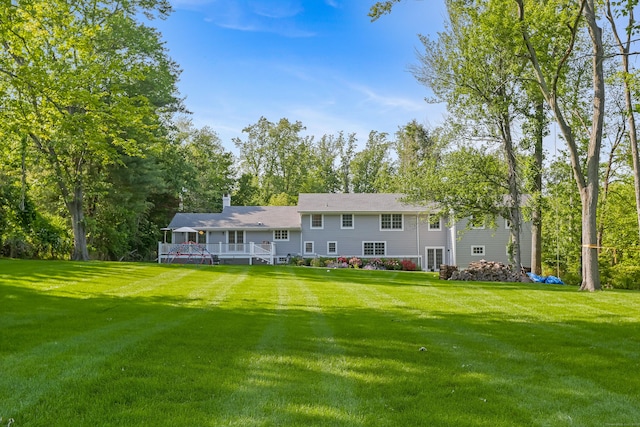 25 Conrad Rd, New Canaan, CT 06840 - back of property featuring a deck, a yard, and a chimney