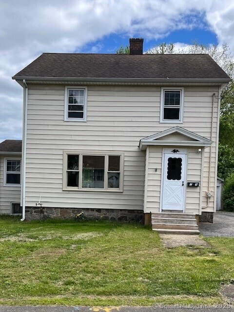 79 Van St, Stratford, CT 06614 - view of front facade featuring entry steps, a chimney, and a front lawn