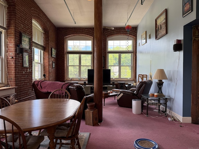 45 Main St Apt 401, Plainfield, CT 06374 - carpeted dining room featuring brick wall and baseboards