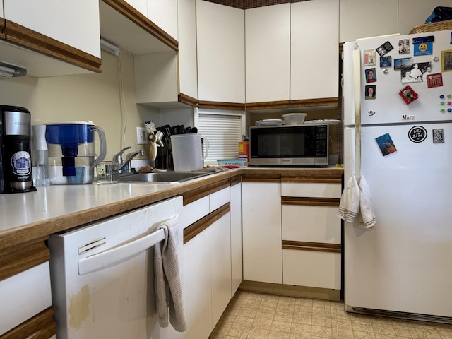 45 Main St Apt 401, Plainfield, CT 06374 - kitchen with freestanding refrigerator, dishwashing machine, stainless steel microwave, and white cabinets