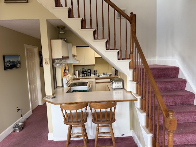 45 Main St Apt 401, Plainfield, CT 06374 - dining room with stairs, baseboards, and dark colored carpet
