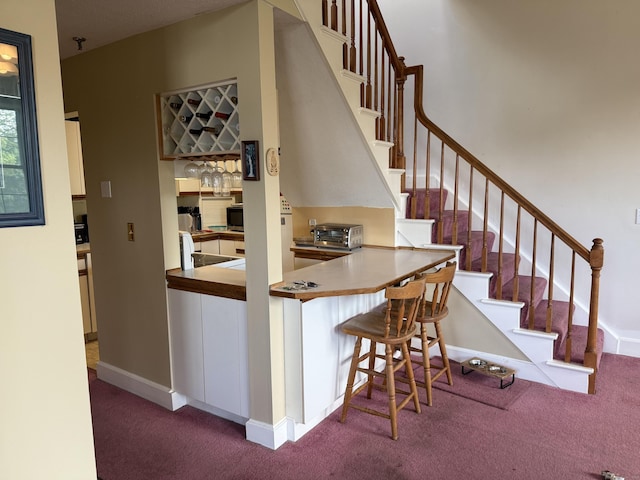 45 Main St Apt 401, Plainfield, CT 06374 - stairway featuring carpet flooring, baseboards, and bar