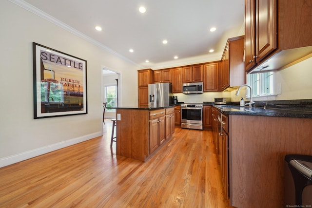 2 Tobins Ct, Danbury, CT 06810 - kitchen featuring appliances with stainless steel finishes, a kitchen bar, ornamental molding, a center island, and healthy amount of natural light