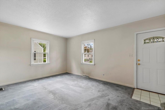 23 Salem Rd, East Hartford, CT 06118 - carpeted entrance foyer with a textured ceiling and baseboards
