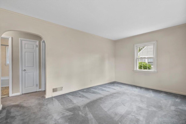 23 Salem Rd, East Hartford, CT 06118 - unfurnished room featuring arched walkways, carpet floors, baseboards, and crown molding