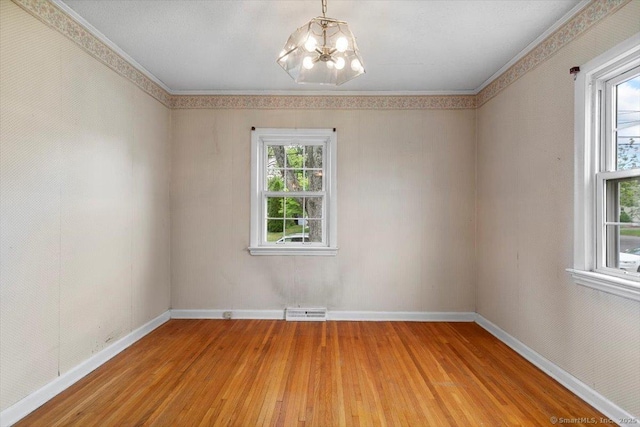 23 Salem Rd, East Hartford, CT 06118 - empty room with light wood finished floors, a chandelier, and baseboards