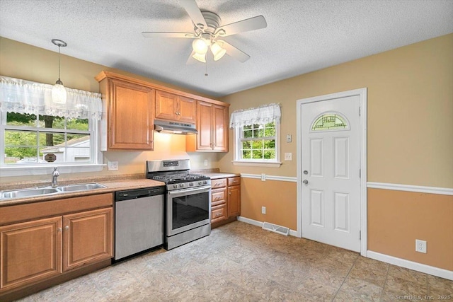 23 Salem Rd, East Hartford, CT 06118 - kitchen with stainless steel appliances, a sink, under cabinet range hood, brown cabinets, and a textured ceiling