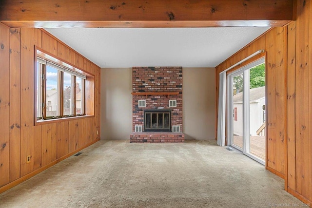 23 Salem Rd, East Hartford, CT 06118 - unfurnished living room featuring wood walls, carpet, beam ceiling, and a fireplace