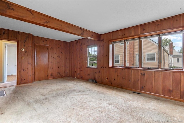 23 Salem Rd, East Hartford, CT 06118 - empty room featuring carpet flooring, wooden walls, and beam ceiling