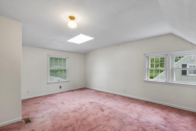 23 Salem Rd, East Hartford, CT 06118 - unfurnished room featuring a skylight, carpet, baseboards, lofted ceiling, and a textured ceiling