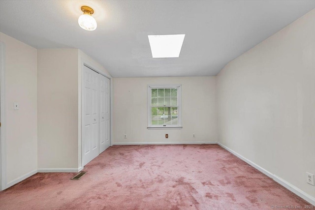 23 Salem Rd, East Hartford, CT 06118 - unfurnished bedroom with carpet flooring, a skylight, baseboards, a closet, and vaulted ceiling