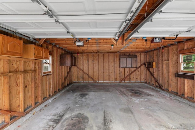 23 Salem Rd, East Hartford, CT 06118 - garage with wood walls and a garage door opener