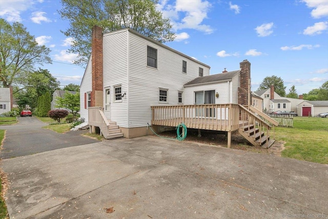 23 Salem Rd, East Hartford, CT 06118 - rear view of house with a chimney and a wooden deck