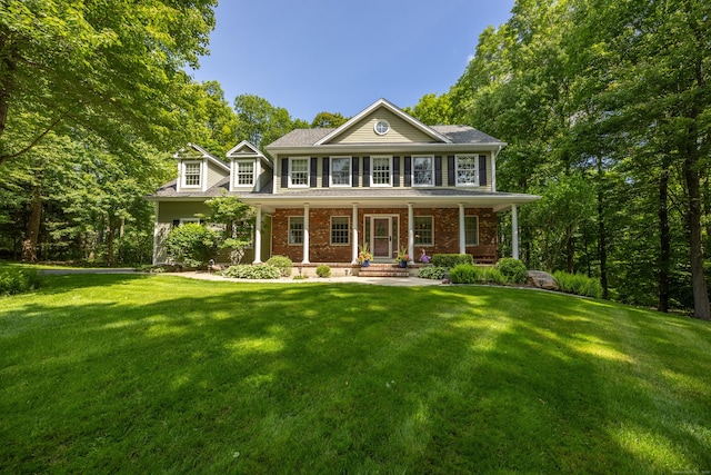 155 Garrigus Ct, Wolcott, CT 06716 - colonial house featuring a front yard, brick siding, and a porch