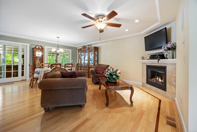 155 Garrigus Ct, Wolcott, CT 06716 - living area featuring a fireplace, a chandelier, ceiling fan, light wood finished floors, and ornamental molding