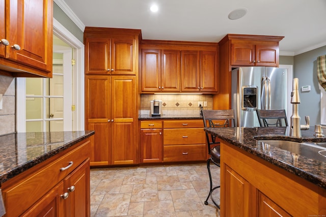 155 Garrigus Ct, Wolcott, CT 06716 - kitchen with stainless steel refrigerator with ice dispenser, decorative backsplash, dark stone countertops, a sink, and light stone finish floors
