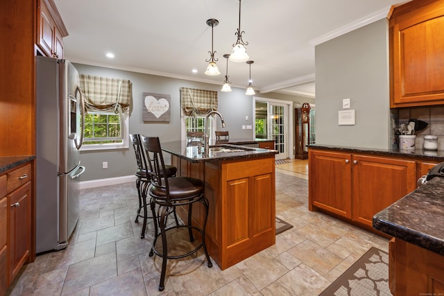 155 Garrigus Ct, Wolcott, CT 06716 - kitchen with stainless steel fridge, a sink, stone tile flooring, baseboards, and crown molding