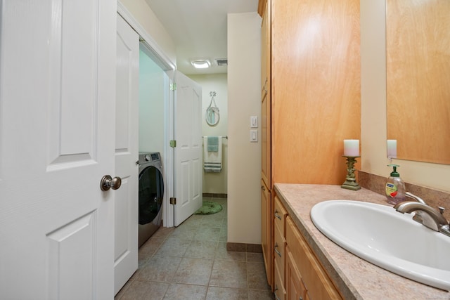 155 Garrigus Ct, Wolcott, CT 06716 - bathroom featuring washer / dryer, vanity, tile patterned floors, and baseboards