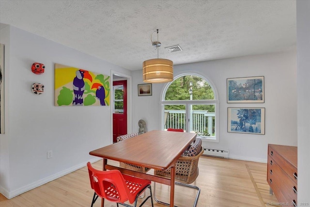 41 Blueberry Cir, Ellington, CT 06029 - dining space with baseboard heating, light wood-type flooring, baseboards, and a textured ceiling