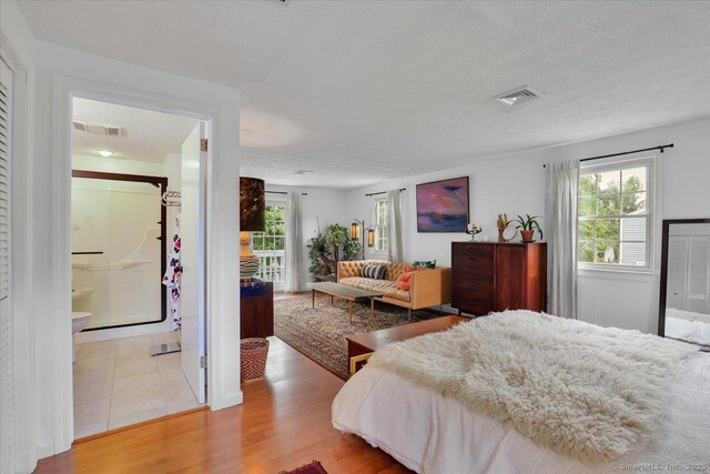 41 Blueberry Cir, Ellington, CT 06029 - bedroom with a textured ceiling, wood finished floors, and ensuite bathroom