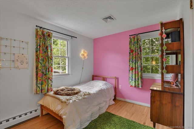 41 Blueberry Cir, Ellington, CT 06029 - bedroom with a baseboard radiator and wood finished floors