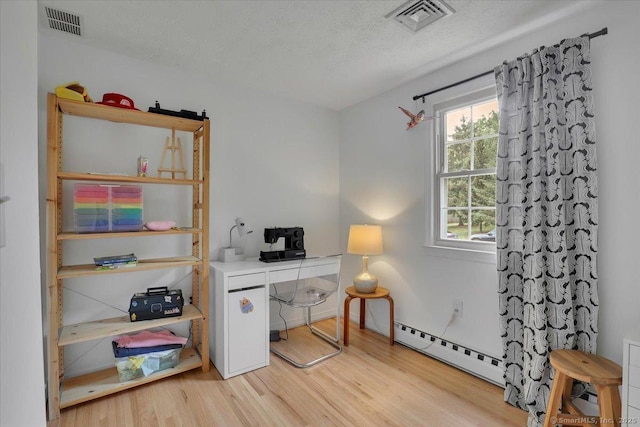 41 Blueberry Cir, Ellington, CT 06029 - office area with a baseboard heating unit, wood finished floors, and a textured ceiling