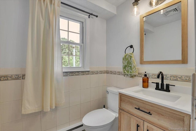 41 Blueberry Cir, Ellington, CT 06029 - bathroom with tile walls, toilet, vanity, and wainscoting