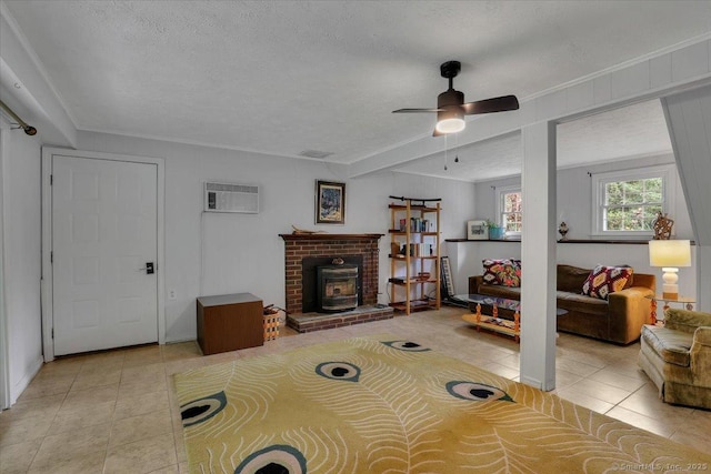 41 Blueberry Cir, Ellington, CT 06029 - living room featuring light tile patterned flooring, a ceiling fan, an AC wall unit, a textured ceiling, and a wood stove