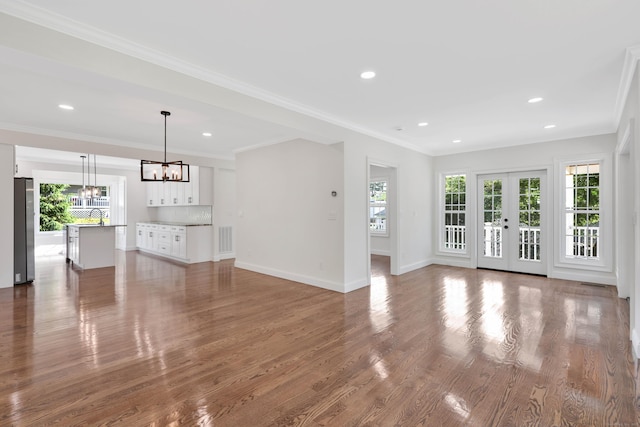 46 N Park St, Ellington, CT 06029 - unfurnished living room featuring plenty of natural light, a chandelier, wood finished floors, baseboards, and recessed lighting