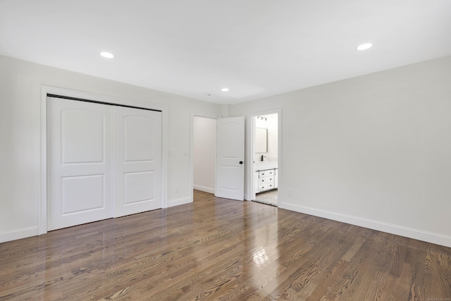 46 N Park St, Ellington, CT 06029 - unfurnished bedroom with a closet, wood finished floors, baseboards, recessed lighting, and connected bathroom