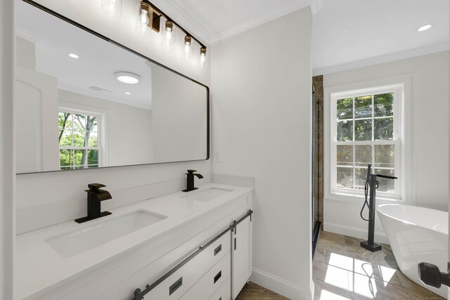 46 N Park St, Ellington, CT 06029 - full bath with healthy amount of natural light, ornamental molding, double vanity, a freestanding bath, and baseboards