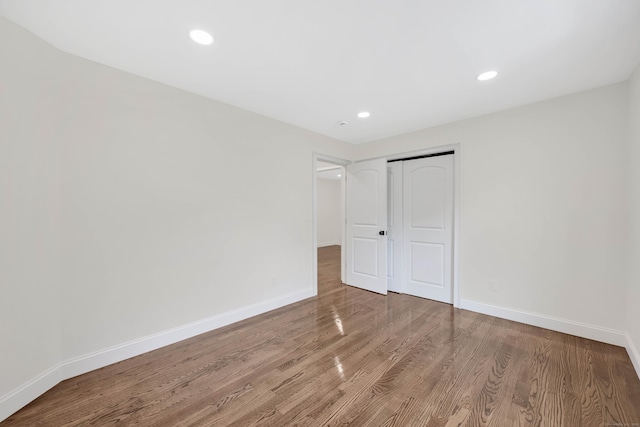 46 N Park St, Ellington, CT 06029 - unfurnished bedroom featuring baseboards, wood finished floors, a closet, and recessed lighting