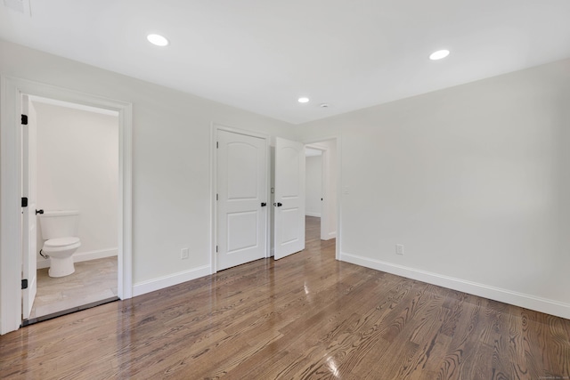 46 N Park St, Ellington, CT 06029 - unfurnished bedroom with baseboards, wood finished floors, recessed lighting, and ensuite bath