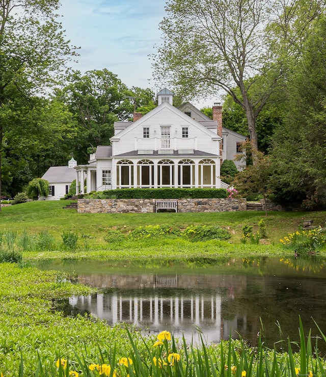 130 Easton Rd, Westport, CT 06880 - rear view of property with a balcony, a chimney, a water view, and a yard