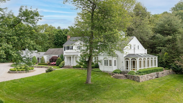 130 Easton Rd, Westport, CT 06880 - view of front of home featuring a chimney, a sunroom, entry steps, and a front lawn