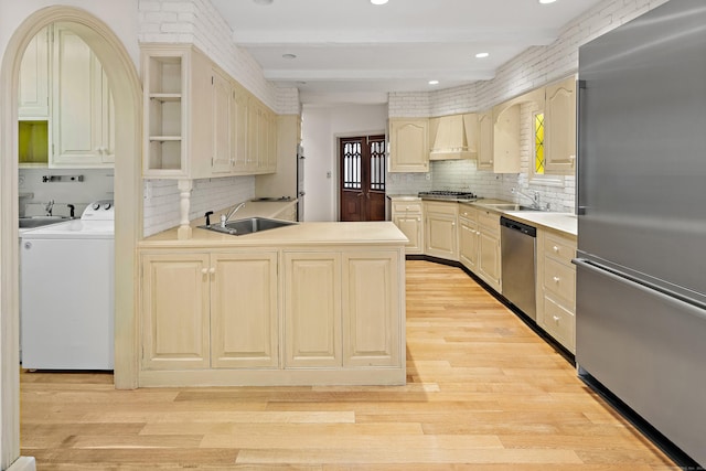 130 Easton Rd, Westport, CT 06880 - kitchen with stainless steel appliances, a sink, decorative backsplash, light wood finished floors, and beamed ceiling