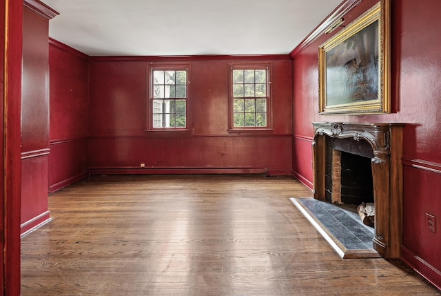 130 Easton Rd, Westport, CT 06880 - unfurnished living room with wood finished floors, a fireplace with raised hearth, crown molding, and a baseboard radiator