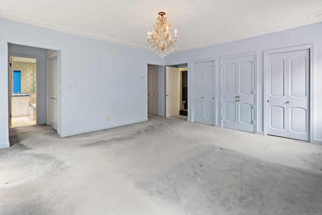 130 Easton Rd, Westport, CT 06880 - unfurnished bedroom with a chandelier, multiple closets, baseboards, carpet, and crown molding