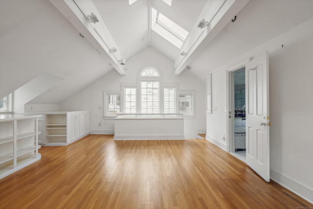 130 Easton Rd, Westport, CT 06880 - unfurnished living room featuring a skylight, vaulted ceiling, and light wood-style floors