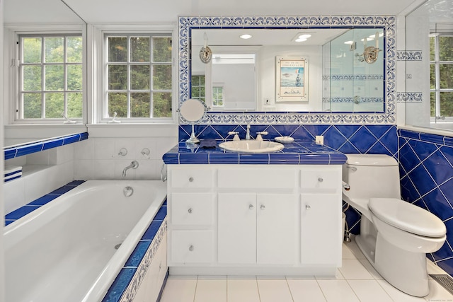 130 Easton Rd, Westport, CT 06880 - bathroom with tile patterned flooring, tile walls, vanity, a bath, and toilet
