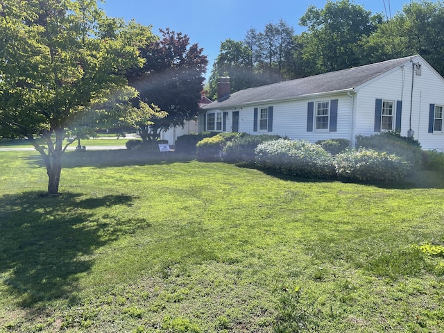 67 Geer St, Cromwell, CT 06416 - view of front of property featuring a chimney and a front yard