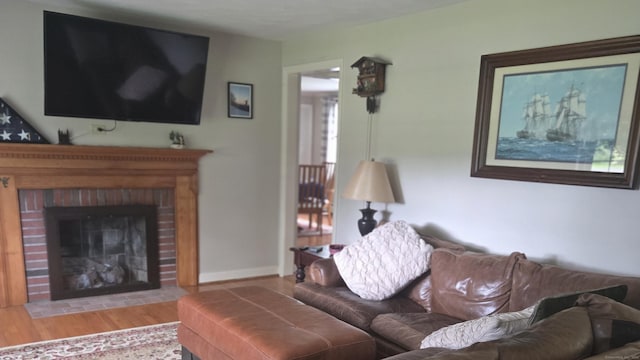 67 Geer St, Cromwell, CT 06416 - living room featuring a fireplace, wood finished floors, and baseboards