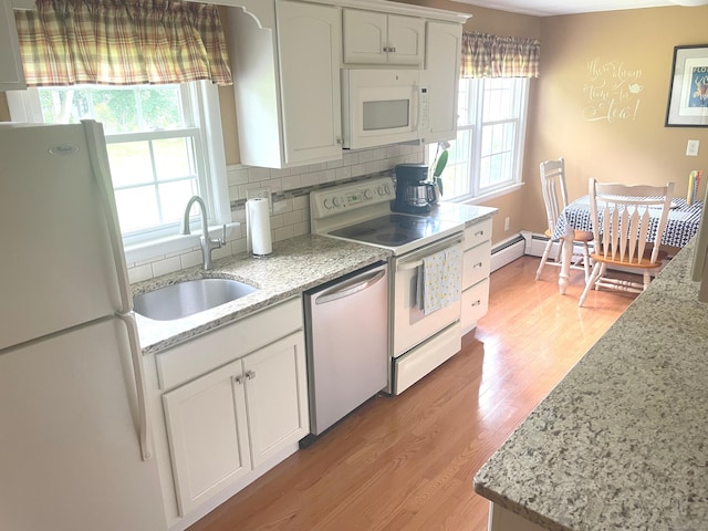 67 Geer St, Cromwell, CT 06416 - kitchen featuring white appliances, a sink, tasteful backsplash, light wood-style floors, and white cabinetry