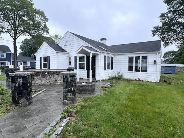 39 Commodore Pl, Milford, CT 06460 - back of house with a lawn, a chimney, a patio area, and a shingled roof