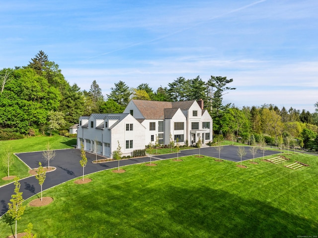 7 Dairy Rd, Greenwich, CT 06830 - view of front of property featuring driveway, a front yard, and a chimney