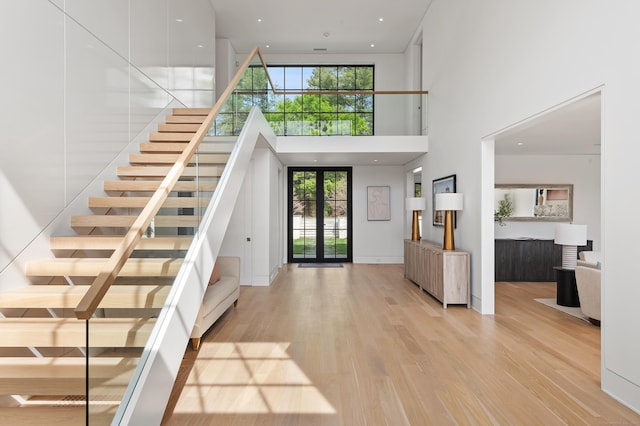 7 Dairy Rd, Greenwich, CT 06830 - foyer featuring a high ceiling, light wood-style flooring, healthy amount of natural light, and stairs