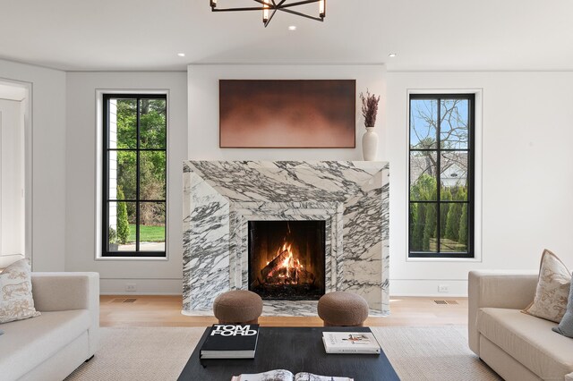 7 Dairy Rd, Greenwich, CT 06830 - living room featuring wood finished floors, healthy amount of natural light, a chandelier, a high end fireplace, and recessed lighting