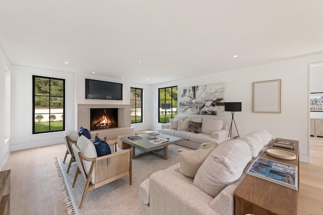 7 Dairy Rd, Greenwich, CT 06830 - living room featuring light wood-style flooring, a warm lit fireplace, and recessed lighting